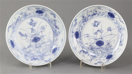 A near pair of Chinese blue and white mandarin duck and pond saucer dishes, Yongzheng mark and of the period (1723-35), diameter 15.5
